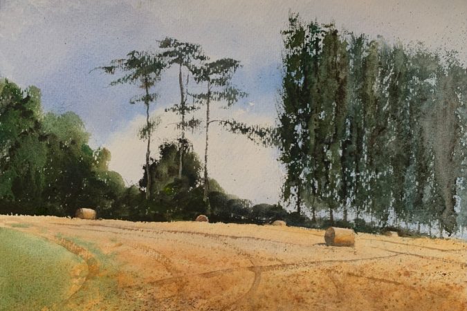 Watercolour painting of a Sussex field with hay bales and trees in the background by artist John Haywood