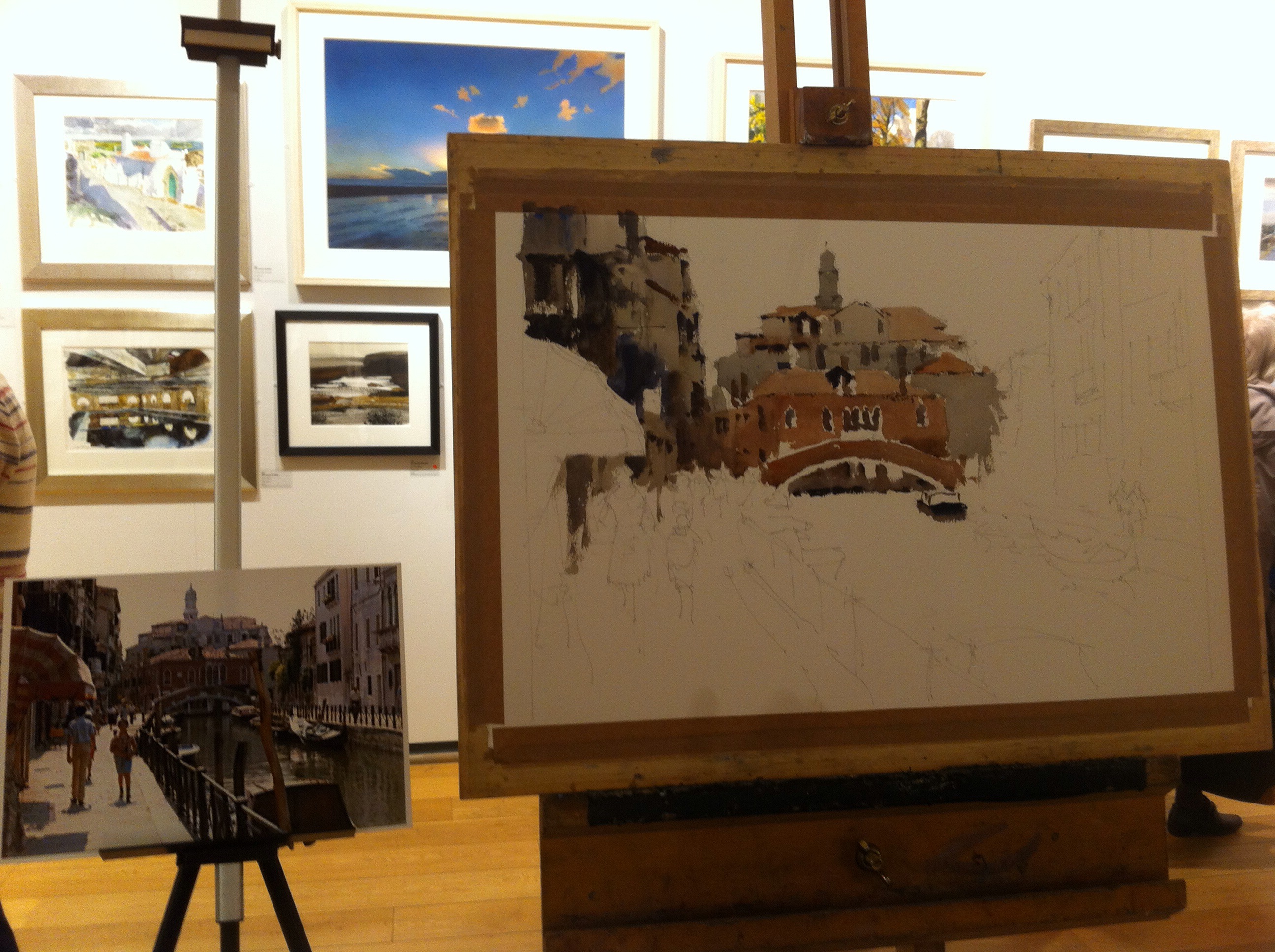 The painting in progress and the source material