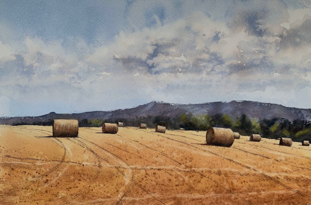 Watercolour painting of some haybales in a Sussex field by artist John Haywood